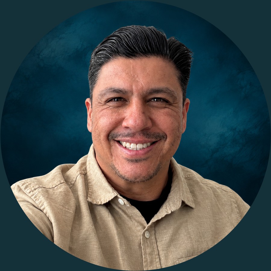 Ruben Magdaleno, smiling, in a tan shirt.